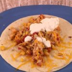 This Easy Baked These easy shredded chicken tacos are made in the crockpot and are perfect for a busy week night dinner.